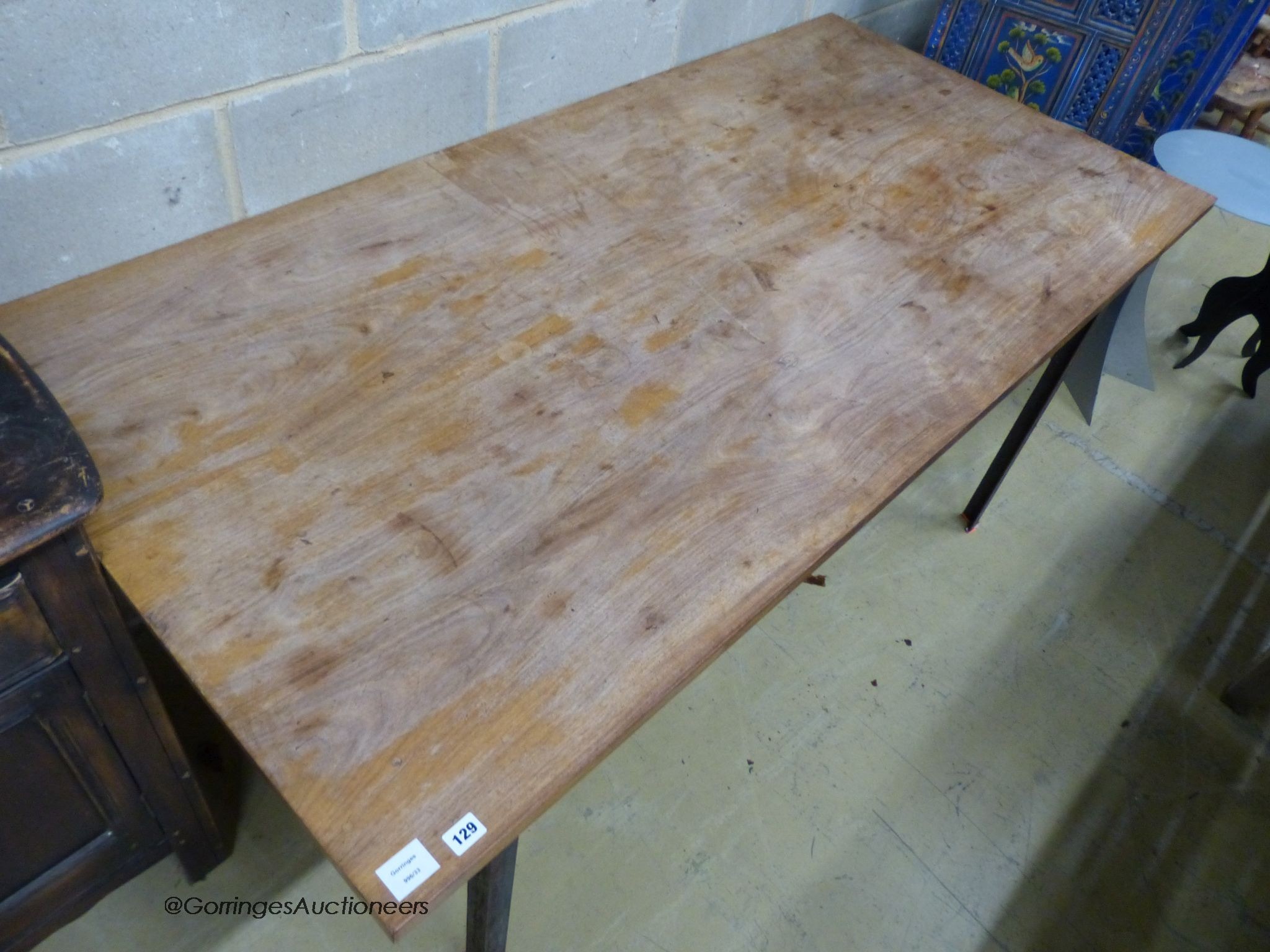 A walnut veneer and steel rectangular dining table, designed and made by Bill Gill, circa 1960, length 185cm, depth 90cm, height 74cm